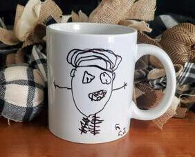 Coffee mug with funny kids stick figure artwork.