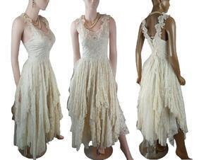 A long, cream tattered wedding dress. Soft varying lengths of fabric in the skirt and has a high low skirt. The shoulder straps have flowers making it very feminine and pretty. One of a kind, handmade, eco-friendly, bohemian style dress.