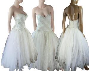 A long, traditional looking tulle wedding dress in white and cream. An adjustable hook and eye corset with loads of lace and a flower. Comes with a short tulle veil. One of a kind, eco-friendly, hand made, bohemian style dress.