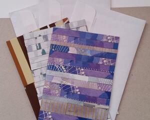 3 handmade patterned cards and enveloped fanned on a table. Patterns include Coffee, Abstract Painting, and Dreams Collage.