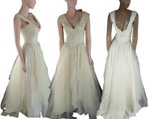 Long cream reworked vintage wedding dress. Lots of tulle and pearls. Decorative bodice with a long full skirt. One of a kind, reworked wedding dress.