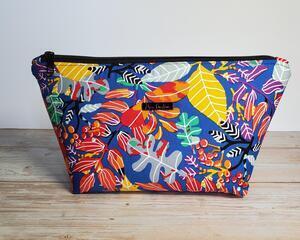 Front of a blue passion leaf, large makeup bag with a gunmetal zipper and gunmetal Bass Creations logo tag.