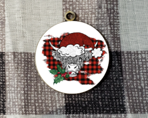 Highland Christmas Cow ornament on buffalo check background