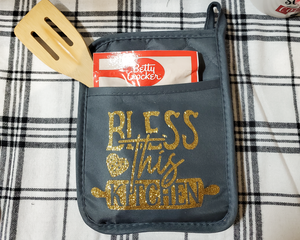 Gray potholder with gold bless this kitchen