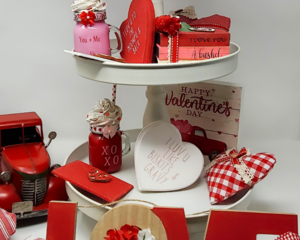 Red tiered tray set displayed on tray with other décor items