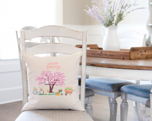 welcome spring flowering tree pillow cover on a dining room chair