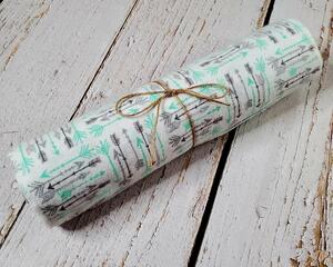 overhead view of teal and tray arrows non-paper towels.