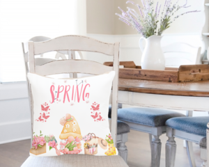 Pink Spring gnome pillow cover displayed on a pillow in a dining chair