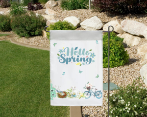 Hello Spring Garden flag in a landscaped garden