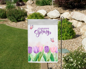 Welcome Spring tulip garden flag in a garden landscape