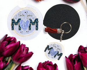 Key chain and carcoaster that says I love you Mom in blue print with a heart shaped "o"