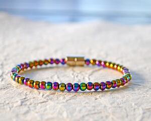 Magnetic bracelet handcrafted with iridescent rainbow hematite magnetic beads. Bracelet is secured with a strong and easy-to-use magnetic clasp.