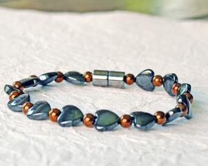 Magnetic bracelet handcrafted with alternating black magnetic hematite heart beads and copper metallic magnetic hematite beads. It is secured with a strong and easy-to--use magnetic clasp.