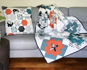 Handmade quilt, 44 X 58, various modern print fabrics in teal, burnt orange, black and ivory on white, floral backing; comes with 20" matching pillow