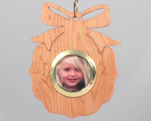 A handmade wood photo ornament featuring a hand-cut design and a customizable photo insert.