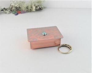 Handmade tiny copper trinket box with faint green patina on embossed lid upcycled from vintage copper platter, and Arkansas Turquoise gemstone cabochon. Shown with my ring for size comparison