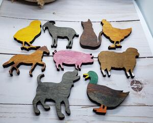 Little wooden animals: yellow chick, a grey goat, dark brown cat, a tan colored chicken, a 2-toned brown horse, a pale pink pig, a light brown sheep, a dak grey pupy, and a brown duck with orange feet and green head.
