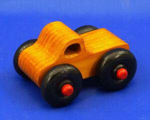 Handmade wooden toy pickup truck with extra large wheels, finished with amber shellac, black, and red paint from my Play Pal Collection.