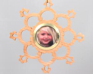 A handmade wood photo ornament featuring a hand-cut design and a customizable photo insert.