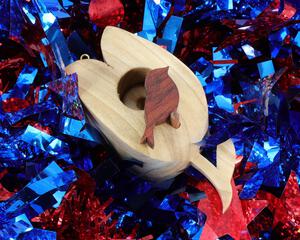 A wooden miniature birdhouse Christmas tree ornament shaped like a tulip, made from light beige wood, with a small dark reddish-brown bird perched at the entrance. It features a gold-colored hanging loop on top.