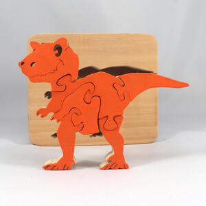 Handmade Wood Dinosaur Tray Puzzle with Amber Shellac and Orange Paint Finish. Freestanding and Versatile Toy for Kids of All Ages, Crafted in the USA with Traditional Woodworking Tools.
