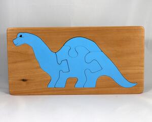 This is a handmade wooden dinosaur tray puzzle with a baby blue dinosaur. The tray is finished with amber shellac. It is lightly used but in like-new condition. This dinosaur is a freestanding and versatile toy for kids of all ages.