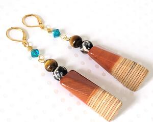 Wood, clay, blue crystal and tigereye dangle earrings, with gold plated lever back ear wires.