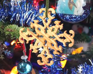 Handcrafted wooden Christmas tree ornament in rustic snowflake style, meticulously finished with clear shellac for a charming holiday touch, proudly made in the USA.