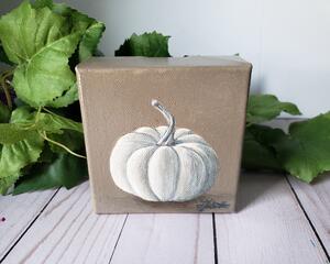 Photo of small square canvas painting of white pumpkin with a light brown background