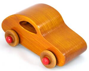 Handmade 1957 Bug Wood Toy Car from My Play Pal Collection, crafted with traditional woodworking tools and finished with amber shellac and bright red trim. Each toy is meticulously assembled and tested for the highest quality.