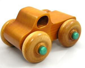 Handmade wooden toy monster truck, crafted in a toymaker's shop with traditional woodworking tools. Finished in amber shellac and metallic emerald green acrylic paint, this sturdy and durable toy is perfect for kids of all ages.