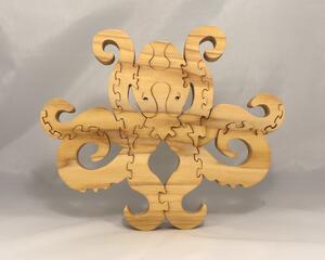 A handcrafted octopus puzzle made from wood. The puzzle is freestanding and can comfortably sit on a shelf, table, window sill, or door frame.