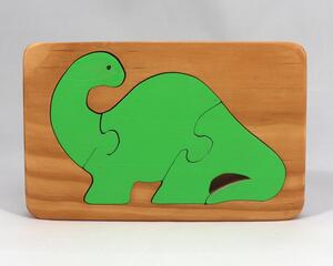Handmade three-piece wooden dinosaur tray puzzle finished with amber shellac and green acrylic paint.