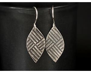 Oxidized sterling silver earrings marquise shaped earrings embossed with a geometric criss cross pattern.