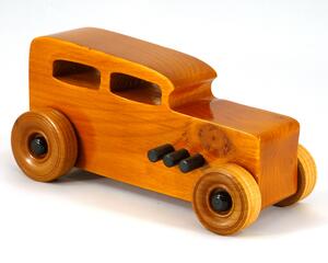 Handmade wood toy car Hot Rod '32 sedan finished with amber shellac with black acrylic paint trim, one of many cars in my Hot Rod collection.