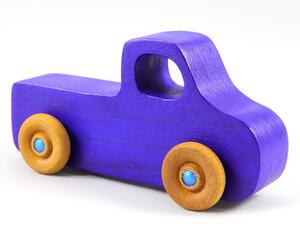 A handmade wooden toy pickup truck painted with bright blue and metallic sapphire blue paint. The wheels are finished with non-marring amber shellac. This toy is part of my Play Pal Collection.