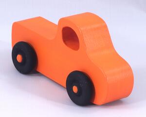 A handmade wooden toy pickup truck painted Pumpkin Orange and Black from my Play Pal Collection