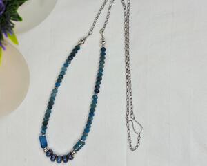 27 inch boho, beachy necklace features blue tumbled porcelain beads and blue apatite beads on stainless steel chain with a handcrafted hook clasp.