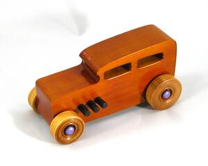 This is a handmade wooden toy car modeled after a Hot Rod 1932 Ford Sedan. It is made from wood, finished with multiple coats of amber shellac, and trimmed with black and metallic purple acrylic paint.