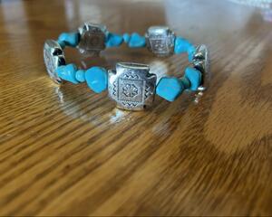 Southwest Concha bracelet with turquoise colored stone beads on stretch cord.