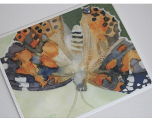 Artistic interpretation of a Painted Lady butterfly in watercolor is printed on textured, acid free fine art paper.  unframed
