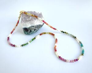 Mix of semi-precious gemstones and pearls, accented with gold detail. Delicate, colorful, a focal point for any solid-color outfit.