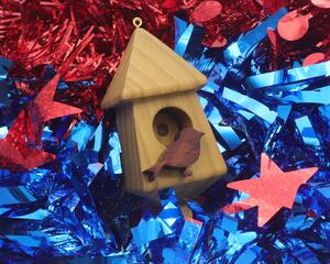 Handmade miniature birdhouse ornament crafted from select hardwoods, featuring a meticulous finish with a beeswax and oil blend—a collectible and charming decorative piece.