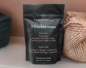 Black pouch next to coral colored yarn