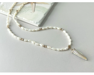 Delicate rice pearl and faceted crystal necklace with rustic, triangular mother-of-pearl pendant. 16" to 19" adjustable length.
