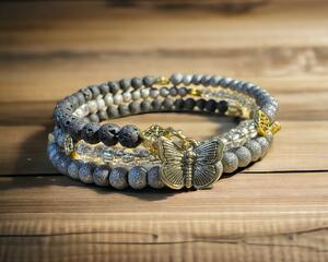 Grey bead stack bracelet with butterfly charm.