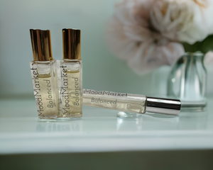 Perfume bottles on table next to flowers