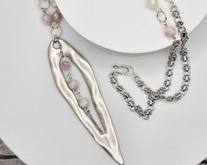 23 inch necklace plus a long 3 inch teardrop shaped pendant. Necklace features lilac colored kunzite beads linked using silver German style wire on rhodium chain.