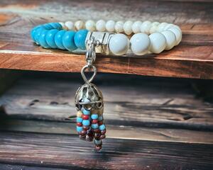 Turquoise colored stones and agate stone beads stretch bracelet with a colorful tassel.