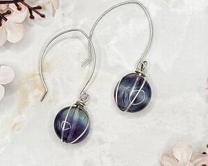 2 inch long earrings are comprised of rainbow flourite beads wrapped using Argentium silver on handmade earring wires.